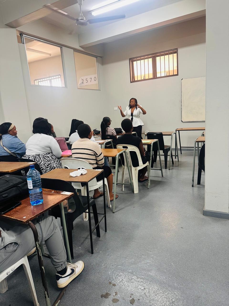 A Juba facilitator presenting to students in a campus classroom